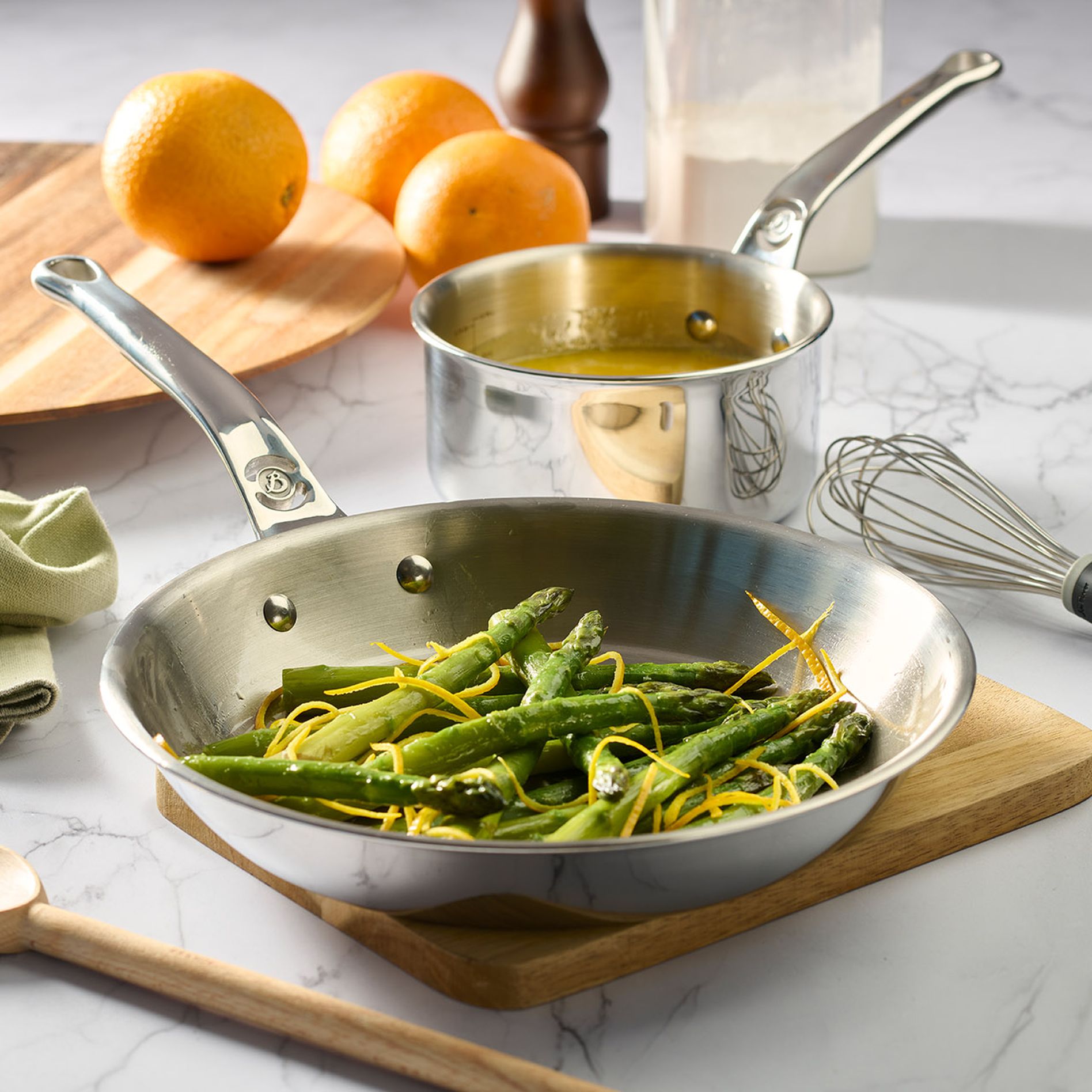 Pan and pot of De Buyer filled with asparagus