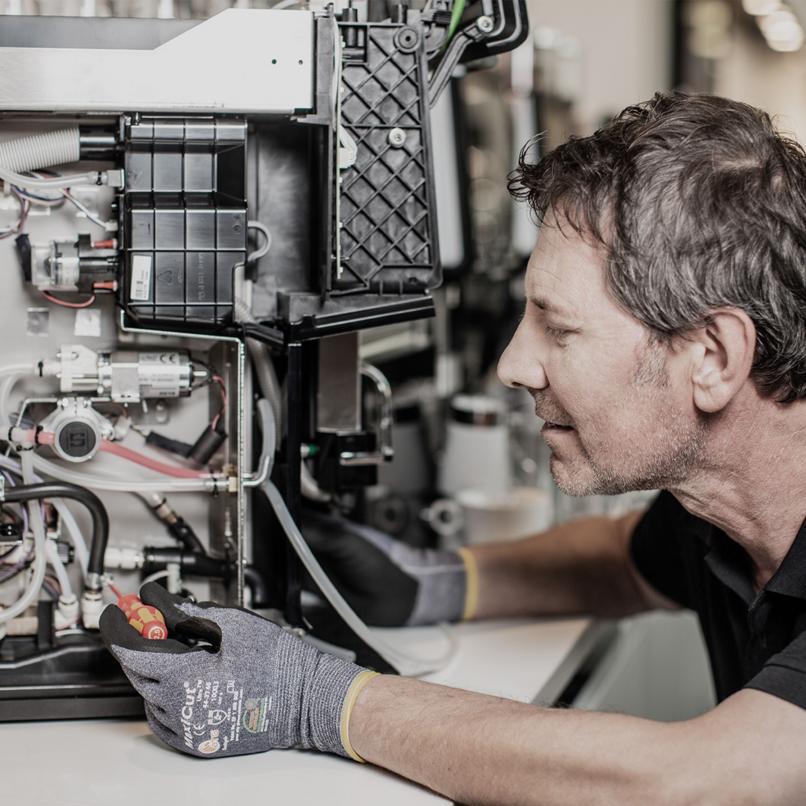 Service technician repairing a coffee machine