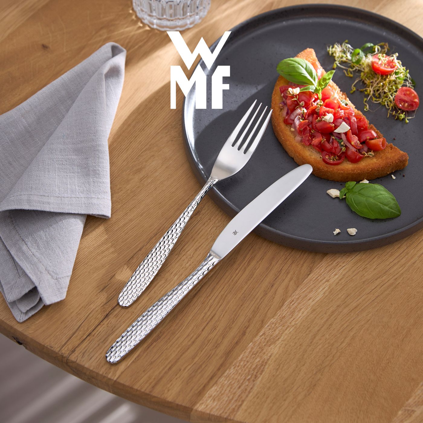WMF cutlery on a table with bruschetta on a plate